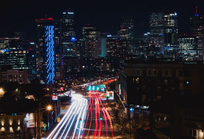 High angle view of illuminated city street and buildings at night