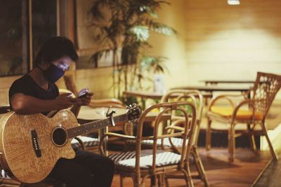 Man playing guitar on table