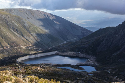 Scenic view of river amidst mountains against sky