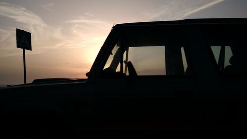 Silhouette of car against sky during sunset
