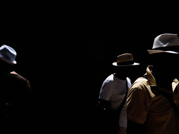 REAR VIEW OF PEOPLE IN HAT