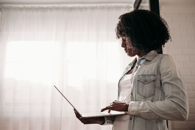 Businesswoman using laptop at home office