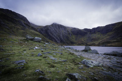 Scenic view of river amidst mountains against sky