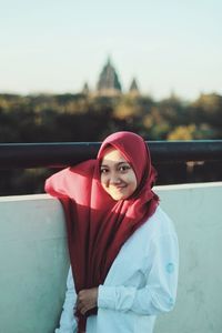 Portrait of girl in hijab standing on terrace