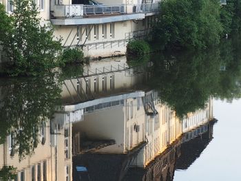 Buildings by river in city