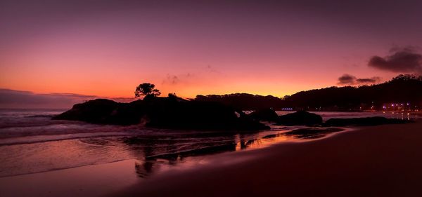 Scenic view of beach at sunset