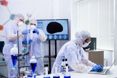 Rear view of female scientist working in laboratory