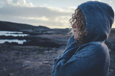 Rear view of woman looking at sea against sky