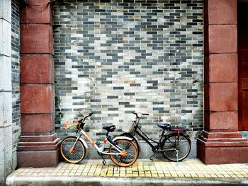 Bicycles parked on wall of building