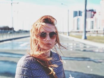 Portrait of young woman wearing sunglasses outdoors