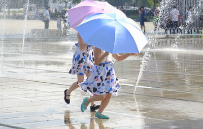 Children playing with umbrellas
