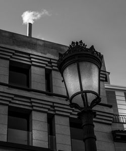 Low angle view of street light against building