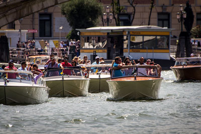 People in boat on river during sunny day