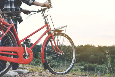 Young person with bicycle outdoors