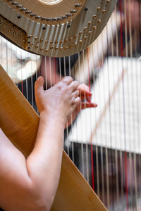 Cropped hand of man playing drum