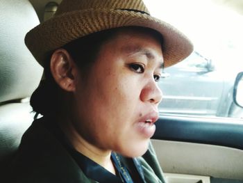 Close-up portrait of happy boy sitting in car