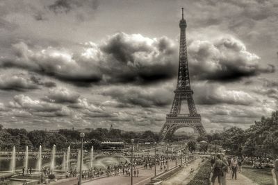 Eiffel tower against cloudy sky