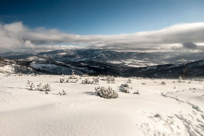 Scenic view of snowcapped mountains against sky