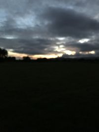 Silhouette of landscape against cloudy sky