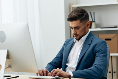 Side view of businessman working at office