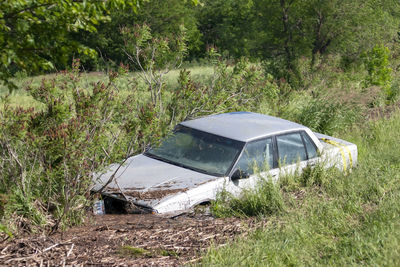 Abandoned car on field