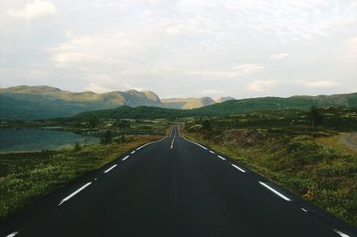 Highway in mountains against sky