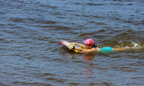 High angle view of girl swimming in sea