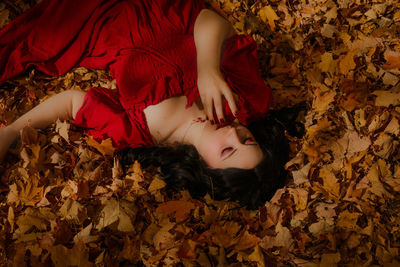 Portrait of young woman standing amidst plants