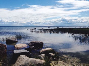 Scenic view of sea against cloudy sky