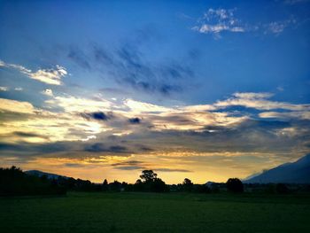 Scenic view of field against sky during sunset