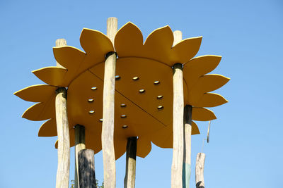 Low angle view of umbrella against clear blue sky