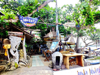 Graffiti on wall by building against trees