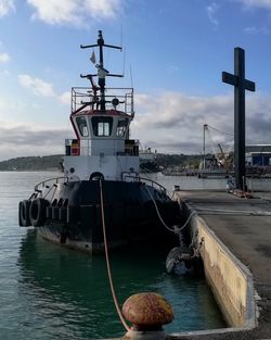 Ship moored on sea against sky