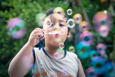Happy boy playing with bubbles