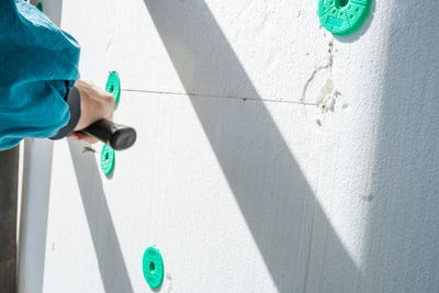 Low section of man standing on wall