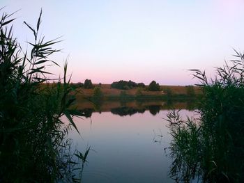 Scenic view of lake against sky at sunset