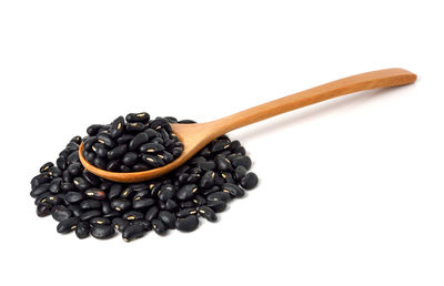 High angle view of coffee beans against white background