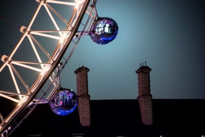 Low angle view of illuminated ferris wheel at night