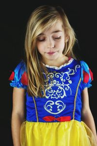 Portrait of girl against black background