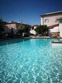 Swimming pool in building against blue sky