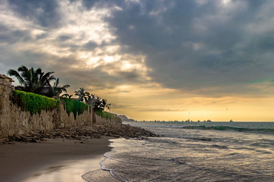 Scenic view of beach against sky during sunset