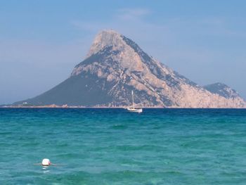 Sailboat in sea against clear sky