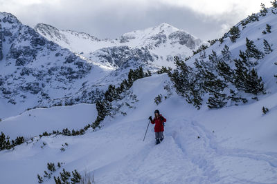 Man skiing on snow covered mountains