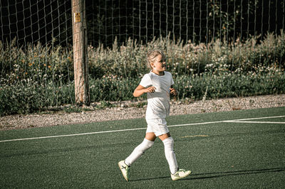 Full length of a boy playing with ball