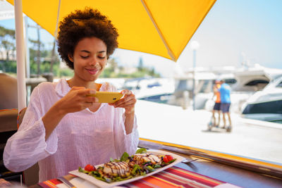 Portrait of young woman holding food