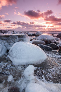 Scenic view of frozen lake against sky during sunset