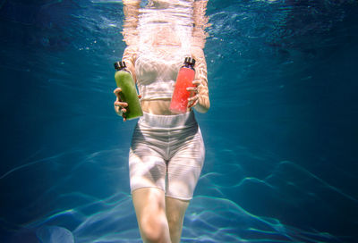 Midsection of woman swimming in sea