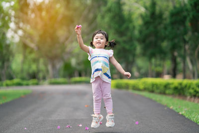 Cute girl jumping outdoors