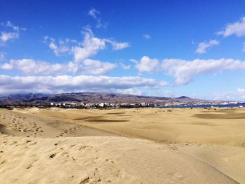 Scenic view of beach against blue sky