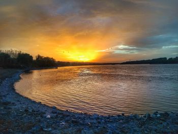 Scenic view of lake against sky during sunset